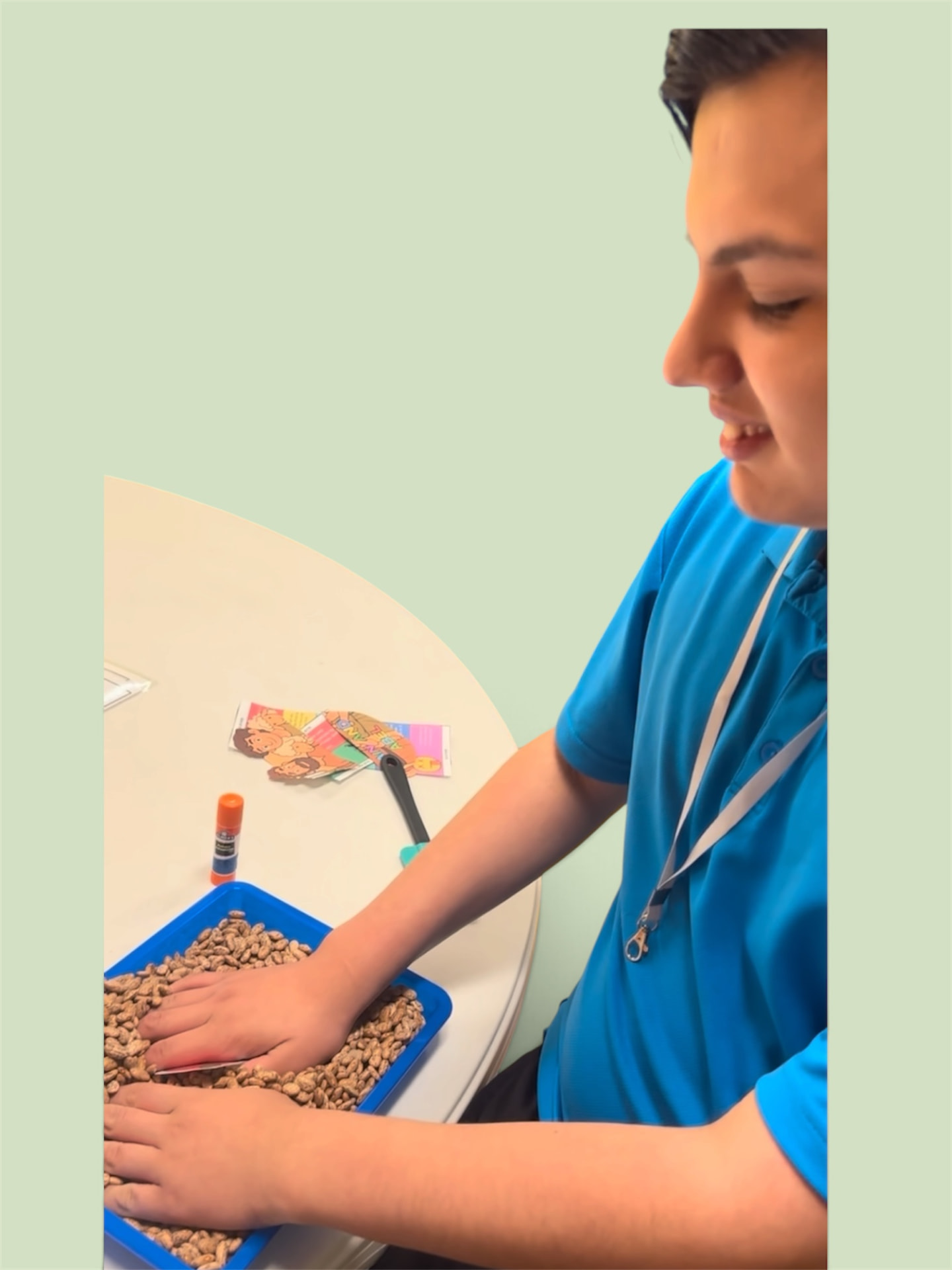 A Project Noah student exploring a sensory bean bin during class